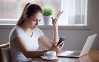 Young woman triggered by the news on her smartphone